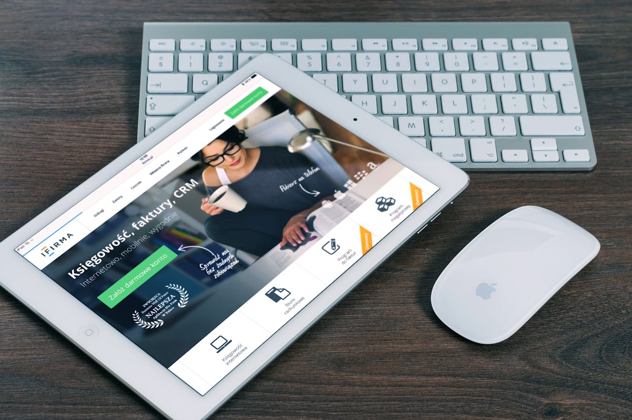 about-us A tablet with a financial website open, alongside a white keyboard and mouse. Ideal for tech-theme stock images.